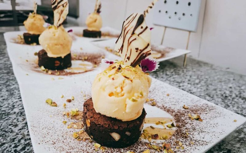 Elegant dessert presentation at Welgelegen Manor Delicious chocolate and vanilla ice cream desserts with garnishes on a white plate.