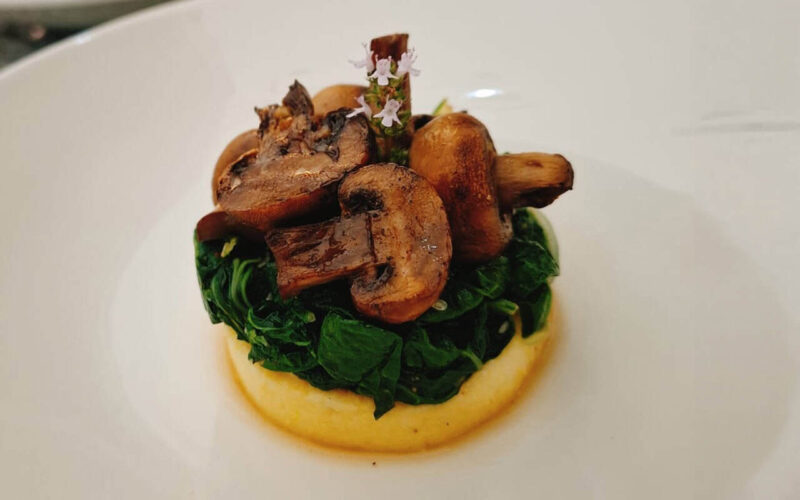 Welgelegen Manor Gourmet Dish Gourmet dish featuring sautéed mushrooms, greens, and a decorative edible flower.